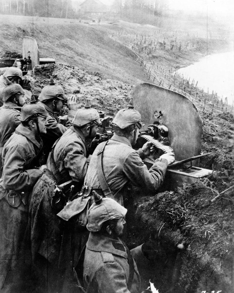 German infantrymen aim machine guns from a trench near the Vistula River in 1916