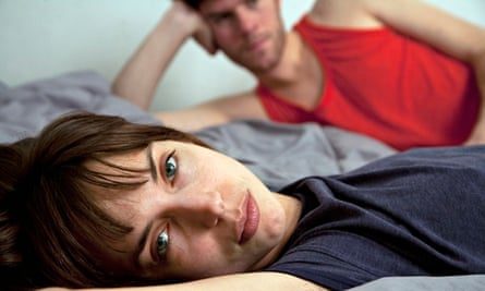 Unhappy-couple-lying-in-b-013