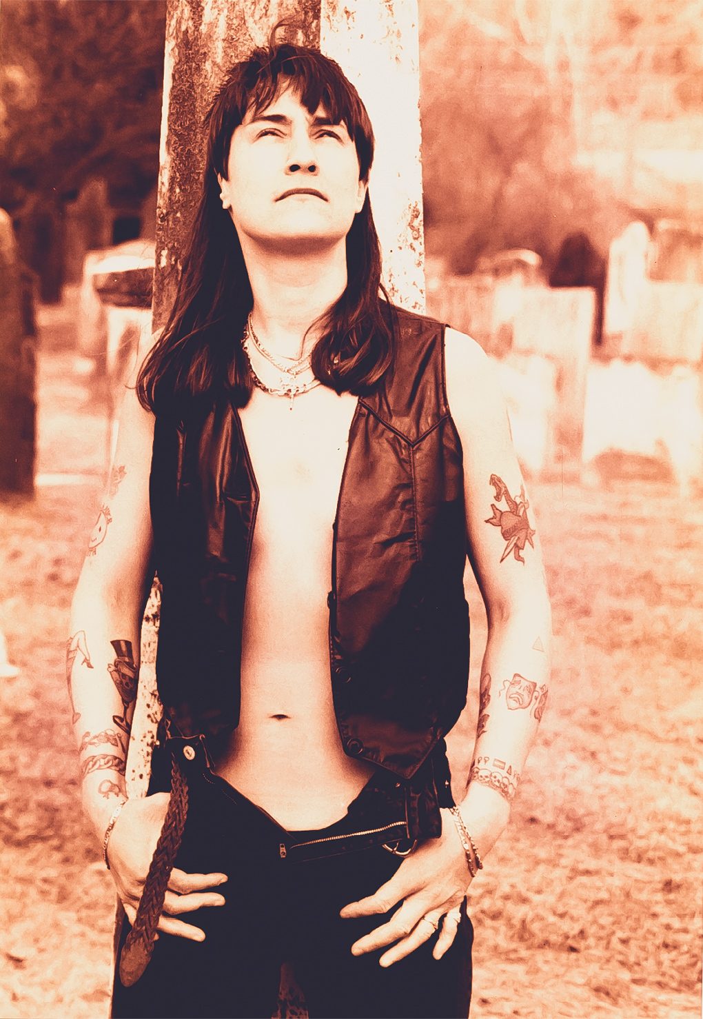 A woman in a cemetery looking up at the sky